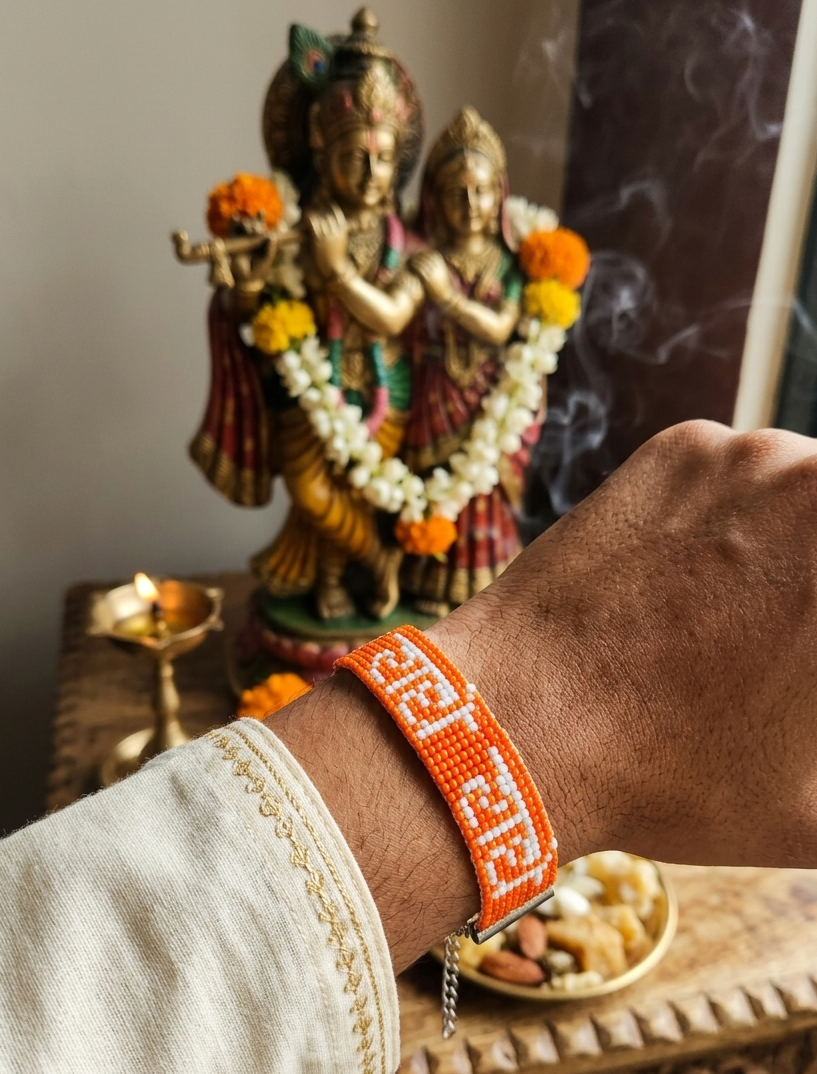 Hand-Woven "Radhe Radhe" Beaded Bracelet in Saffron & White