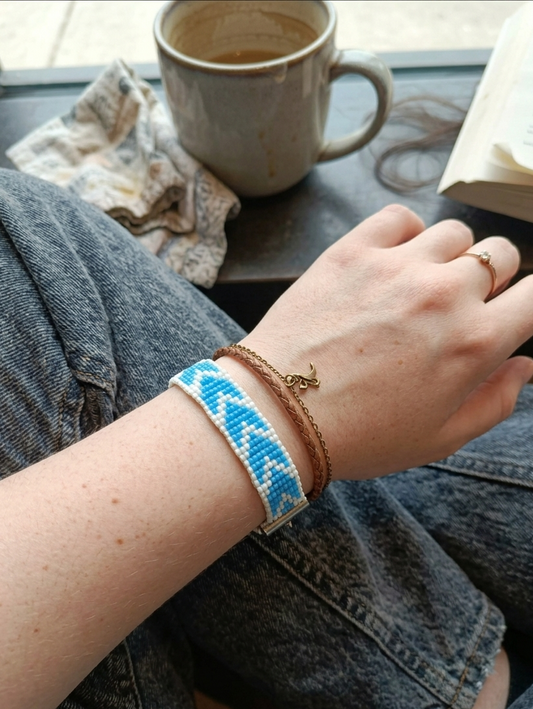 Handcrafted blue and white geometric seed bead loom bracelet with silver adjustable chain