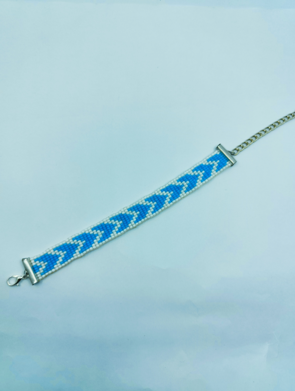 Handcrafted blue and white geometric seed bead loom bracelet with silver adjustable chain